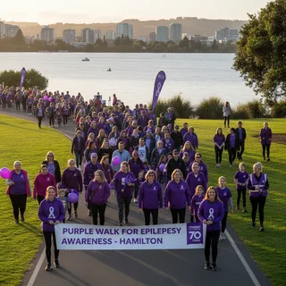 A photorealistic regional news photograph showing people walking around a lake dressed in purple for epilepsy awareness.